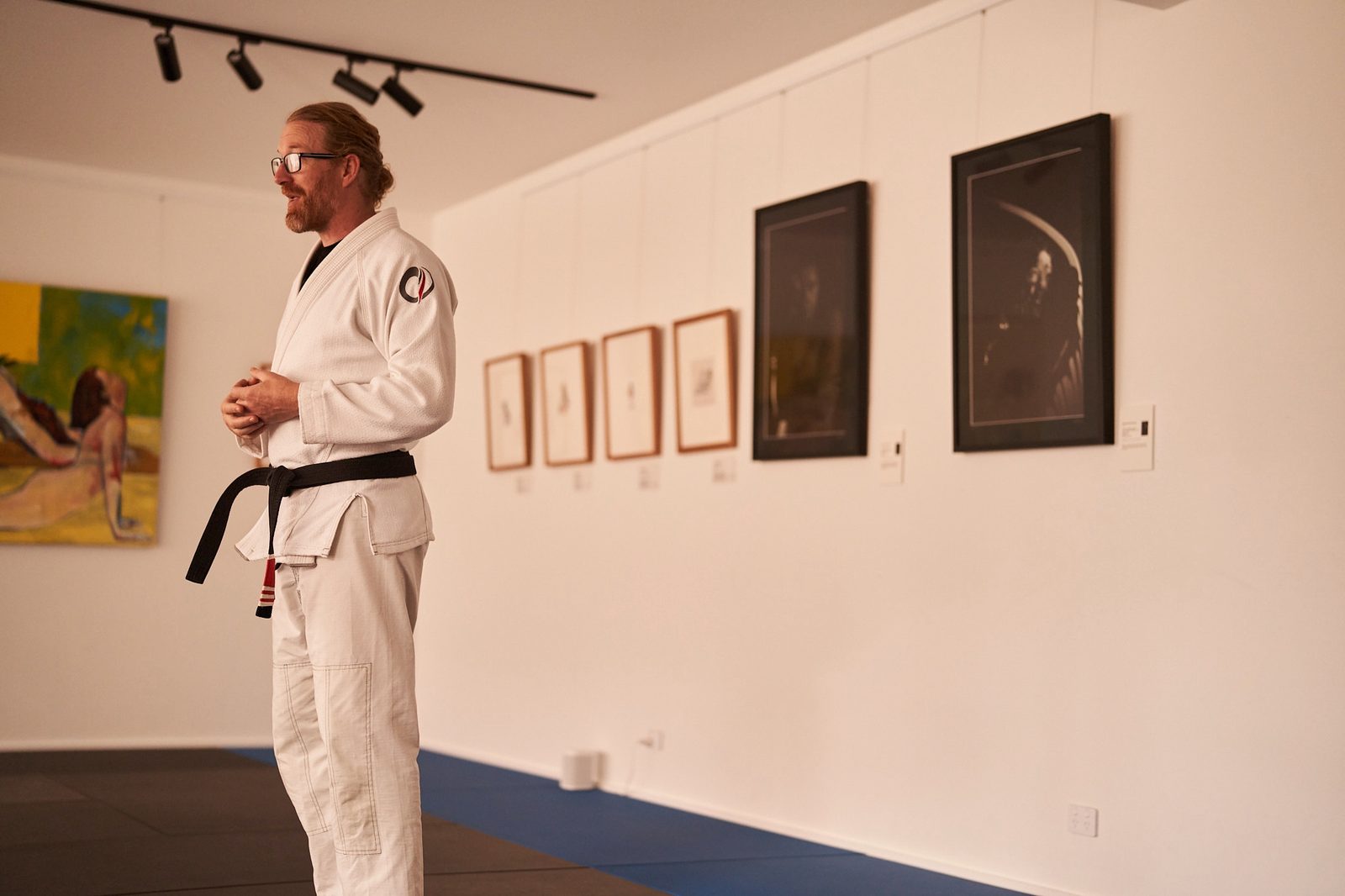 The coach smiles while talking to the adult class.