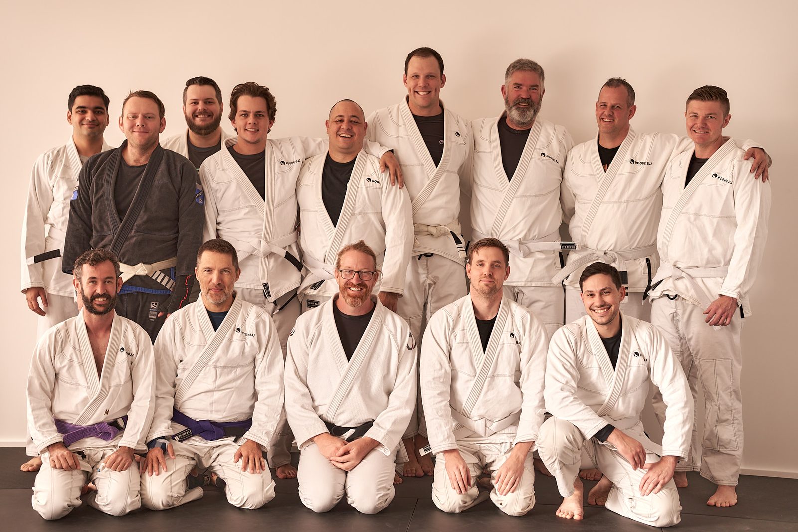The full Rogue BJJ group in gis posed together for a team photo.