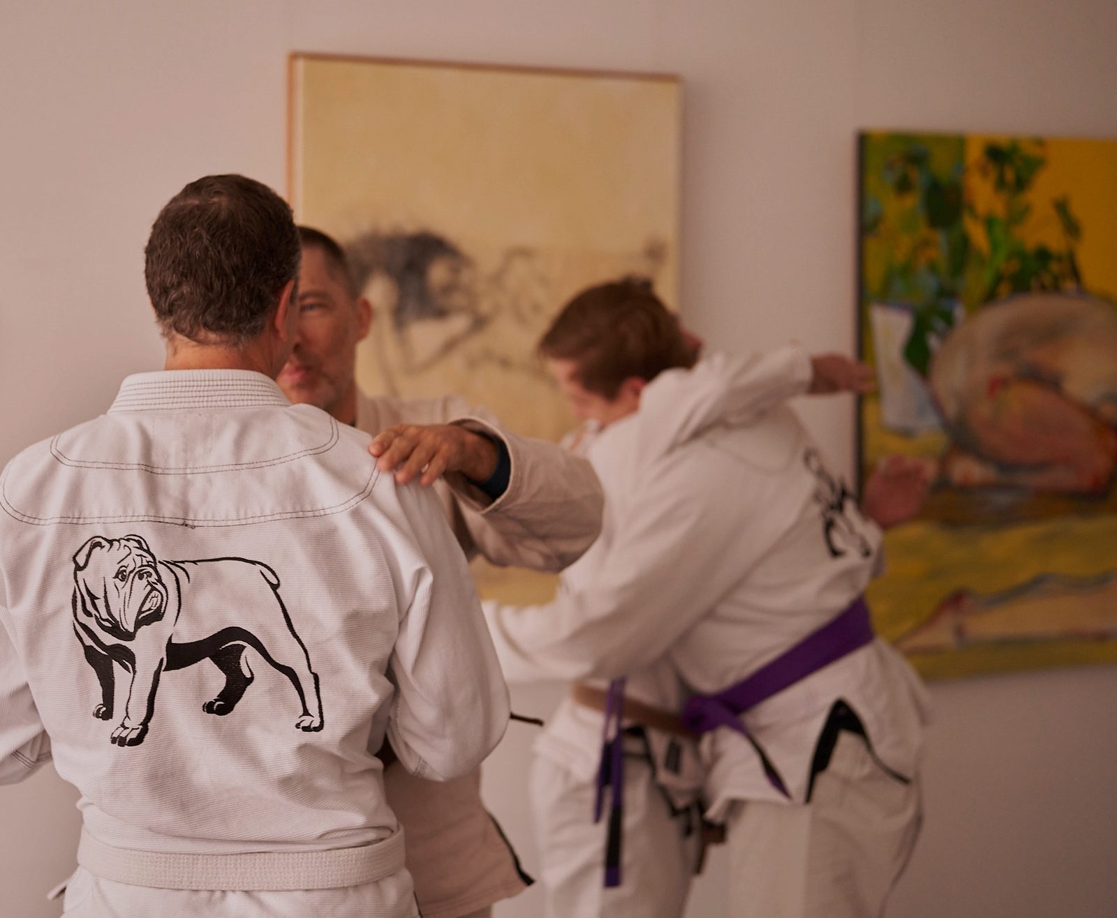 The back of a Rogue BJJ gi jacket, the bulldog logo across the shoulders, worn on the mats during a class.